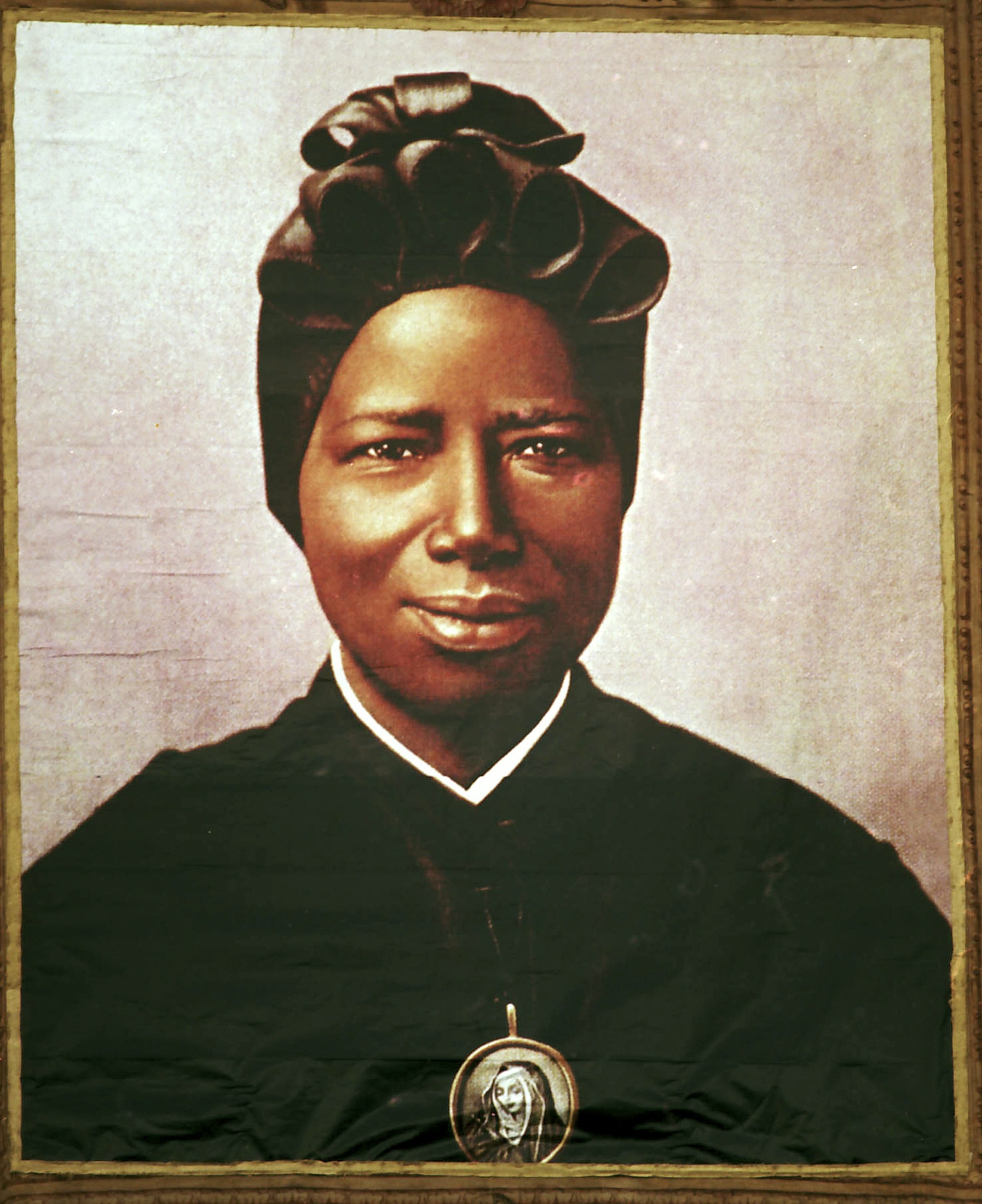 Tapestry of St. Josephine Bakhita hangs from St. Peter's Basilica during her canonization ceremony. (CNS photo/L'Osservatore Romano via Reuters) (Sept. 5, 2008)