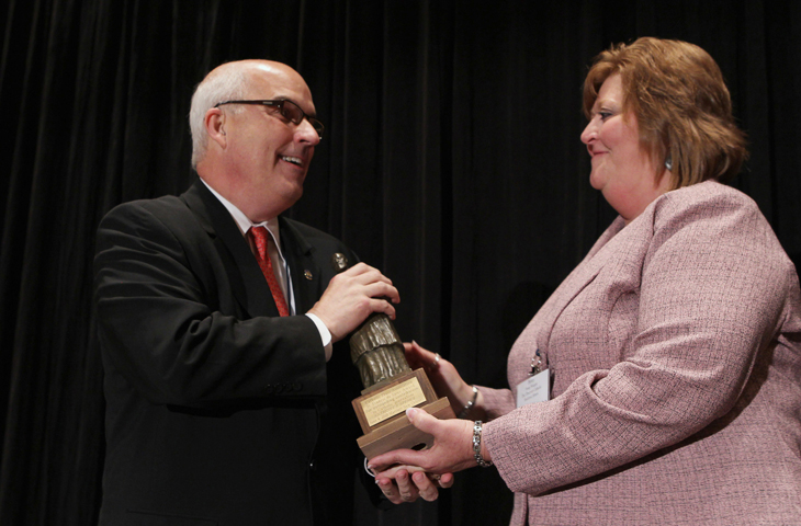 Tony Spence accepts the 2010 St. Francis de Sales award from Penny Wiegert June 4, 2010, during the Catholic Media Convention in New Orleans. (CNS/Nancy Wiechec)