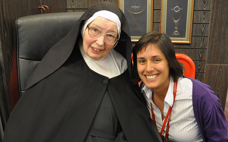 In this 2011 file photo, Sr. Wendy Beckett poses with an unidentified admirer during a book signing at St. Paul's Bookshop in London. (CNS/Jo-Anne Rowney, courtesy of St. Paul's Bookshop)