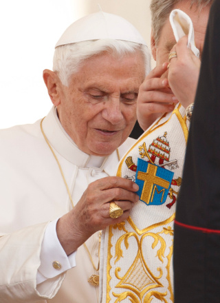 Pope Benedict XVI receives a gift of a stole with the coat of arms of Blessed John Paul IIl during his general audience in St. Peter's Square at the Vatican May 2, 2012. (CNS/Paul Haring)