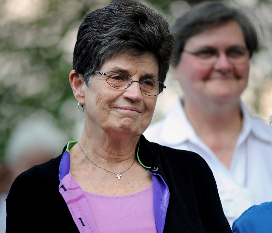 Franciscan Sister Pat Farrell, president of the Leadership Conference of Women Religious, smiles during a blessing by supporters at an Aug. 9 rally of laypeople and religious gathered for the LCWR's 2012 assembly in St. Louis. (CNS photo/Sid Hastings)