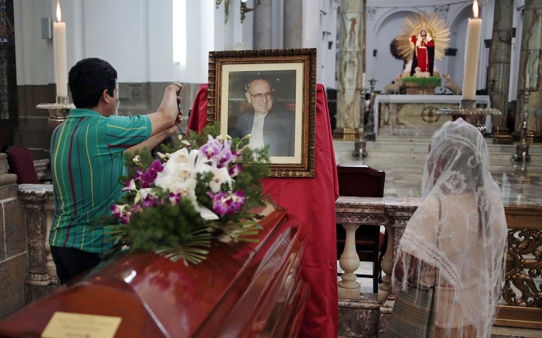 People stand around the casket of Auxiliary Bishop Juan Gerardi at the cathedral in Guatemala City April 25, 2013, in observance of the 15th anniversary of his murder. (CNS/Jorge Dan Lopez, Reuters)