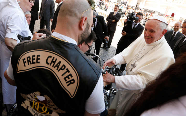 Pope Francis greets a Harley-Davidson biker as he meets with pilgrims who have disabilities following Mass in St. Peter's Square at the Vatican June 16. (CNS/Paul Haring