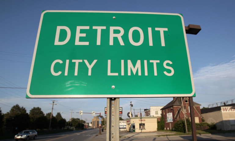 A"'Detroit City Limits" sign is seen in late July as traffic enters a west side neighborhood in Detroit. Residents and political leaders remain uncertain following the city's bankruptcy filing but they are responding "with a lot of grit," said Detroit Ar chbishop Allen H. Vigneron. (CNS photo/Rebecca Cook, Reuters)