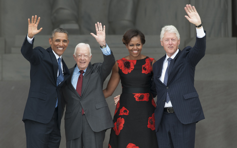 President Barack Obama, standing with former Presidents Jimmy Carter and Bill Clinton, and first lady Michelle Obama, wave from the Lincoln Memorial Aug. 28, 2013. (CNS/Matthew Barrick)