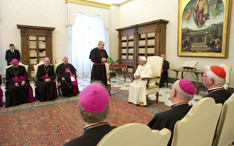 Vienna Cardinal Christoph Schönborn, standing, talks with Pope Francis during a meeting with Austrian bishops at the Vatican Jan. 30. (CNS/Reuters/L'Osservatore Romano)