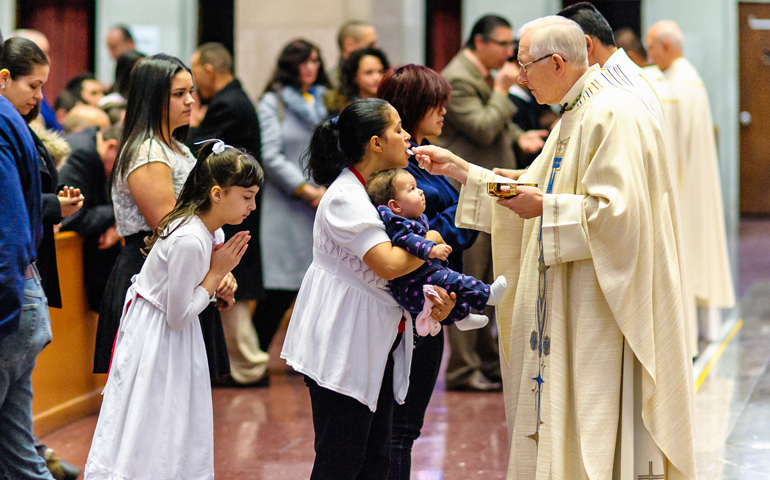 Archbishop Leonard Blair of Hartford, Conn., gives Communion during a Mass in honor of Our Lady of Altagracia at the Cathedral of St. Joseph in Hartford, in this 2014 file photo (CNS/Bob Mullen)
