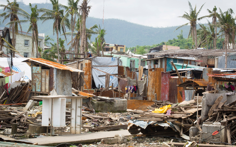 Photos shows homes left in ruins months after Typhoon Haiyan hits central Philippines This photo taken Feb. 10, 2014, from the home of Emmanuel and Maria Rosevilla Margate shows homes left in ruins in Tacloban, Philippines. The family huddled together in their block home Nov. 8, 2013, as Typhoon Haiyan made shambles of many homes in their commun ity known as Barangay 54A. (CNS photo / Tyler Orsburn)