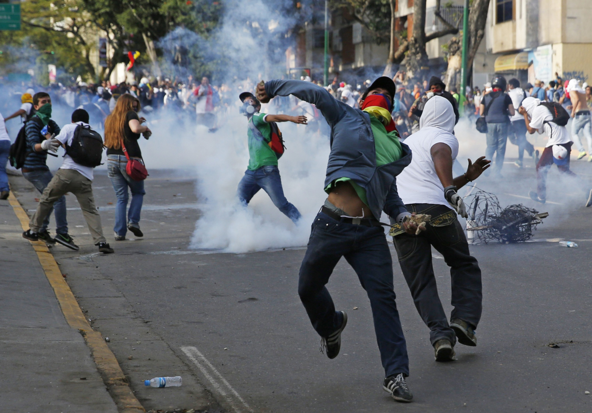 Demonstrators confront police during a protest against the government of President Nicolas Maduro in Caracas, Venezuela, Feb. 22. The country's Catholic leaders urged dialogue and respect for the demonstrators' human rights. (CNS photo/Carlos Garcia Rawl ins, Reuters) (Feb. 25, 2014) 