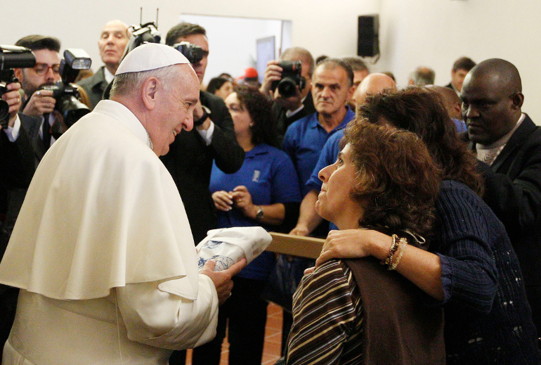 Pope Francis meets with the poor in 2013 at the archbishop's residence in Assisi, Italy. Pope Francis' most frequent advice and exhortation to Catholics: "Go forth." (CNS/Paul Haring)