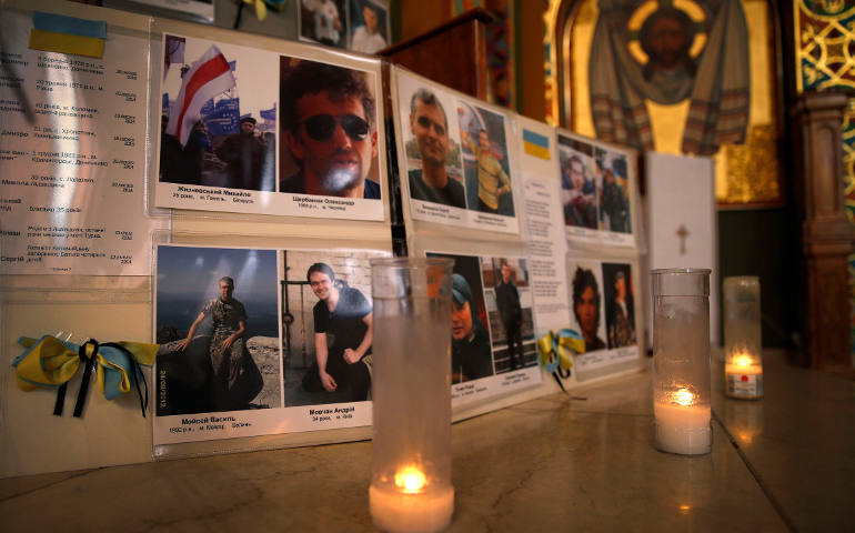 Pictures of victims of the recent protest violence in Kiev, Ukraine, are displayed near the altar during a morning prayer service at the St. George Ukrainian Catholic Church in New York City March 4. (CNS photo/Mike Segar, Reuters)