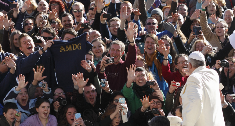 Students from the Gaming, Austria, campus of Franciscan University of Steubenville, Ohio, cheer as Pope Francis arrives to lead his general audience in St. Peter's Square at the Vatican March 5. (CNS/Paul Haring) 