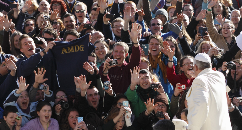 Students from the Gaming, Austria, campus of Franciscan University of Steubenville, Ohio, cheer as Pope Francis arrives to lead his general audience in St. Peter's Square at the Vatican March 5. (CNS/Paul Haring)