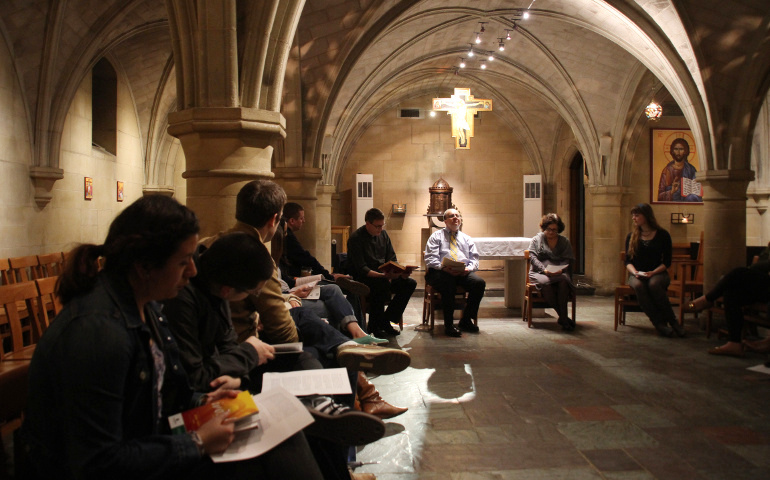 Ennio Mastroianni, center, helps lead a group of catechumens with Father Patrick Rogers and Minerva San Juan in Copley Crypt Chapel of the North American Martyrs at Georgetown University in Washington Feb. 20, 2014. (CNS/Ashleigh Buyers)