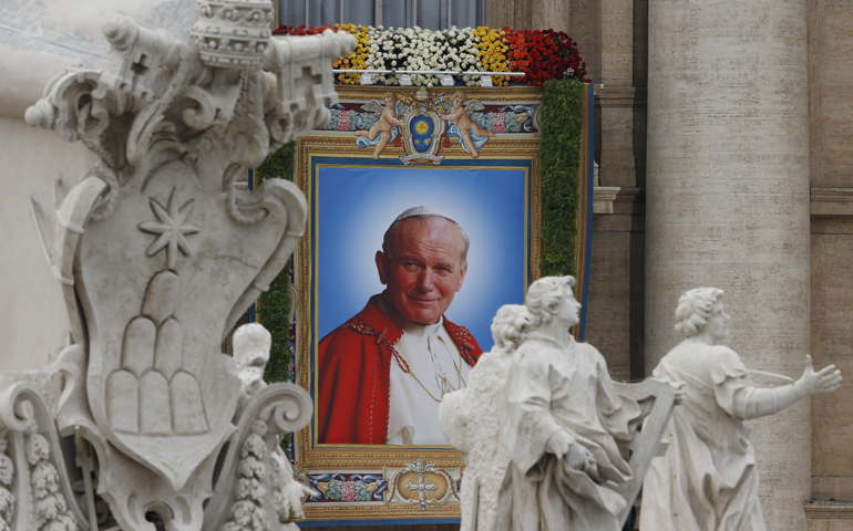 A banner depicting St. John Paul II hangs from the facade of St. Peter's Basilica at the Vatican, in this 2014 file photo.