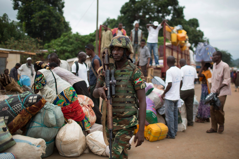 An African Union soldier patrols as people prepare to be evacuated with the help of an armed convoy escorted by African Union peacekeepers, near Bangui, Central African Republic. (CNS/Reuters/Siegfried Modola)
