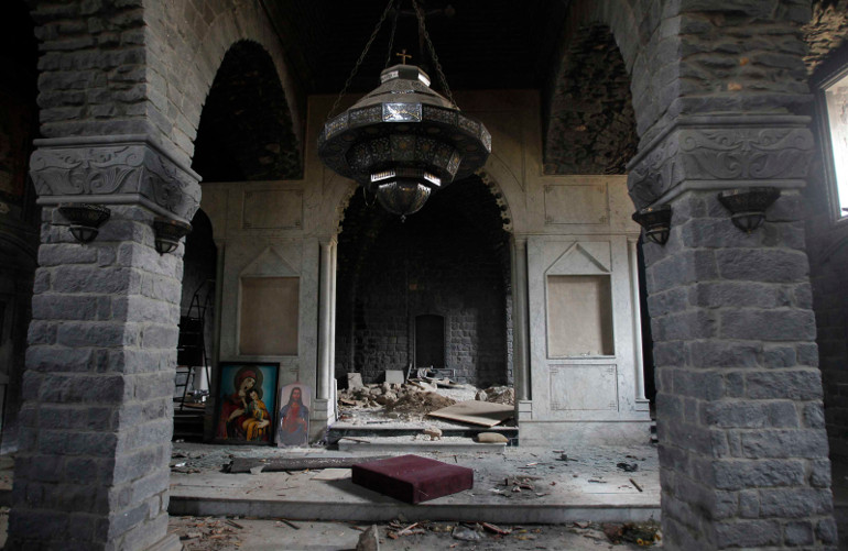 Paintings of Mary and Christ are seen in the damaged Um al-Zenar church in Homs, Syria, May 9. (CNS/Reuters/Khaled al-Hariri)