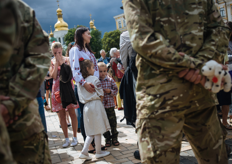 Relatives and friends attend an allegiance ceremony of a Ukrainian army battalion in Kiev before they depart to eastern Ukraine June 23. (CNS/EPA/Roman Pilipey)