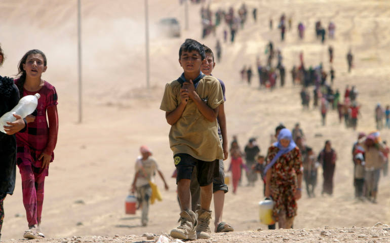 Children flee violence from forces loyal to the Islamic State in Sinjar, Iraq, Aug. 10. Islamic State militants have killed at least 500 Yezidi ethnic minorities, an Iraqi human rights minister said. (CNS photo/Rodi Said, Reuters)