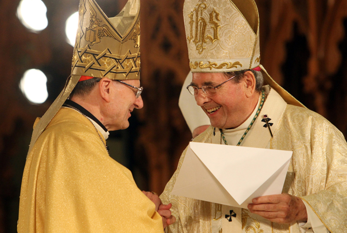Archbishop John J. Myers of Newark, N.J. (right), smiles as he receives an apostolic letter from Cardinal Angelo Amato during the beatification Mass for Blessed Miriam Teresa Demjanovich in Newark, Oct. 4, 2014. (CNS/