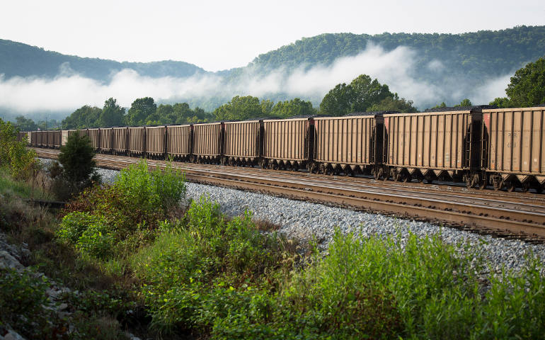 A train carries coal near Ravenna, Ky., Aug. 21. Throughout the mining region of central Appalachia, mountaintop removal mining has flattened more than 500 mountains and led to more than 2,000 miles of steams being filled in, according to The Alliance for Appalachia. (CNS photo/Tyler Orsburn)
