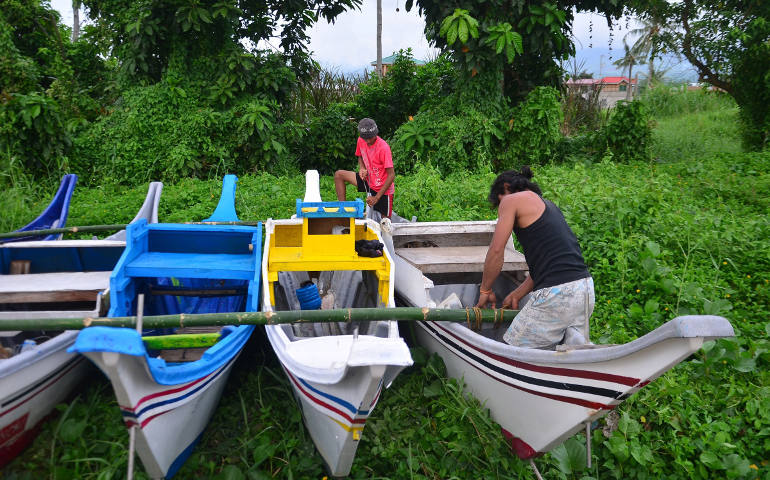 Filipino fishermen secure their fishing boats during a pre-emptive evacuation in Ormoc City, Philippines, Dec. 4 as Typhoon Hagupit continued to gain strength and take aim on the central part of the island nation. (CNS photo/Robert Dejon, EPA)