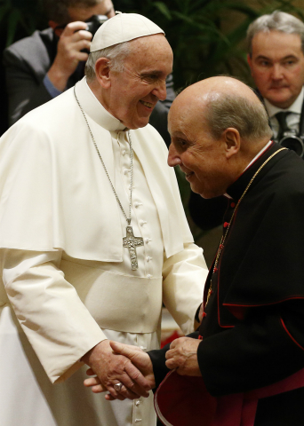 Pope Francis greets Bishop Javier Echevarria Rodriguez, head of the personal prelature of Opus Dei, during an audience to exchange Christmas greetings with members of the Roman Curia in Clementine Hall at the Vatican Dec. 22, 2014. (CNS photo/Paul Haring)