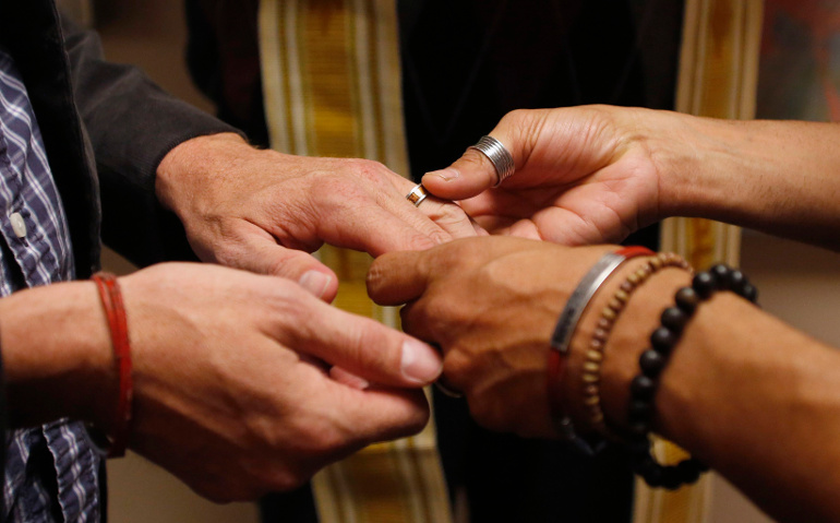 A same-sex couple exchange rings during a marriage ceremony in early October at the Salt Lake County Government Complex in Salt Lake City. (CNS/Reuters/Jim Urquhar) 