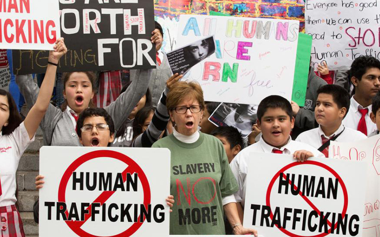 People march with signs protesting human trafficking during a "Walk 4 Freedom" Jan. 9, 2015, in Los Angeles. (CNS/Vida Nueva/Victor Aleman)
