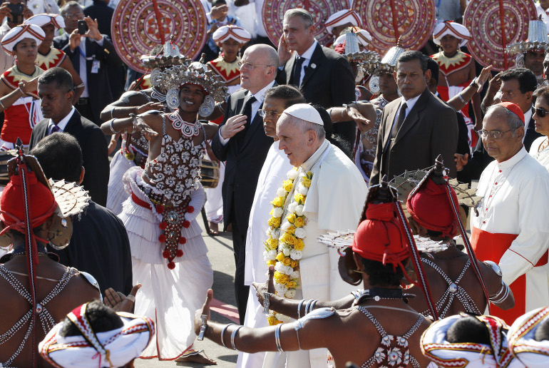 To the sounds of traditional dancers and drummers, Pope Francis arrives at the international airport in Colombo, Sri Lanka, Jan. 13. (CNS photo/Paul Haring) 