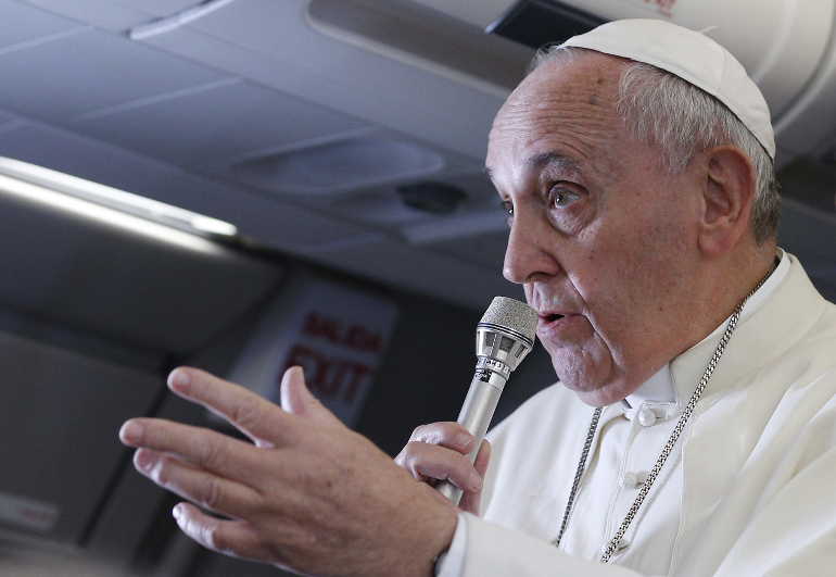 Pope Francis answers questions from journalists aboard his flight from Manila, Philippines, to Rome Jan. 19. (CNS photo/Paul Haring)
