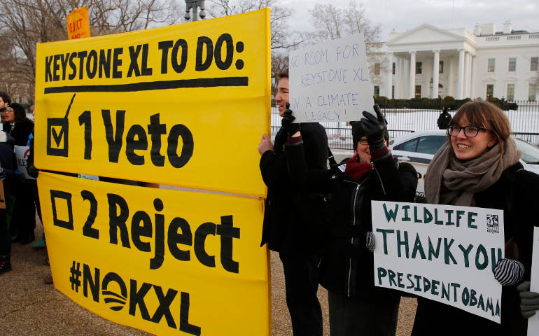 Veto supporters rally in front of the White House Feb. 24, the same day U.S. President Barack Obama vetoed a bill passed by the House and Senate to approving construction of the Keystone XL oil pipeline that would run from Canada to the Gulf Coast. (CNS photo/Larry Downing, Reuters)