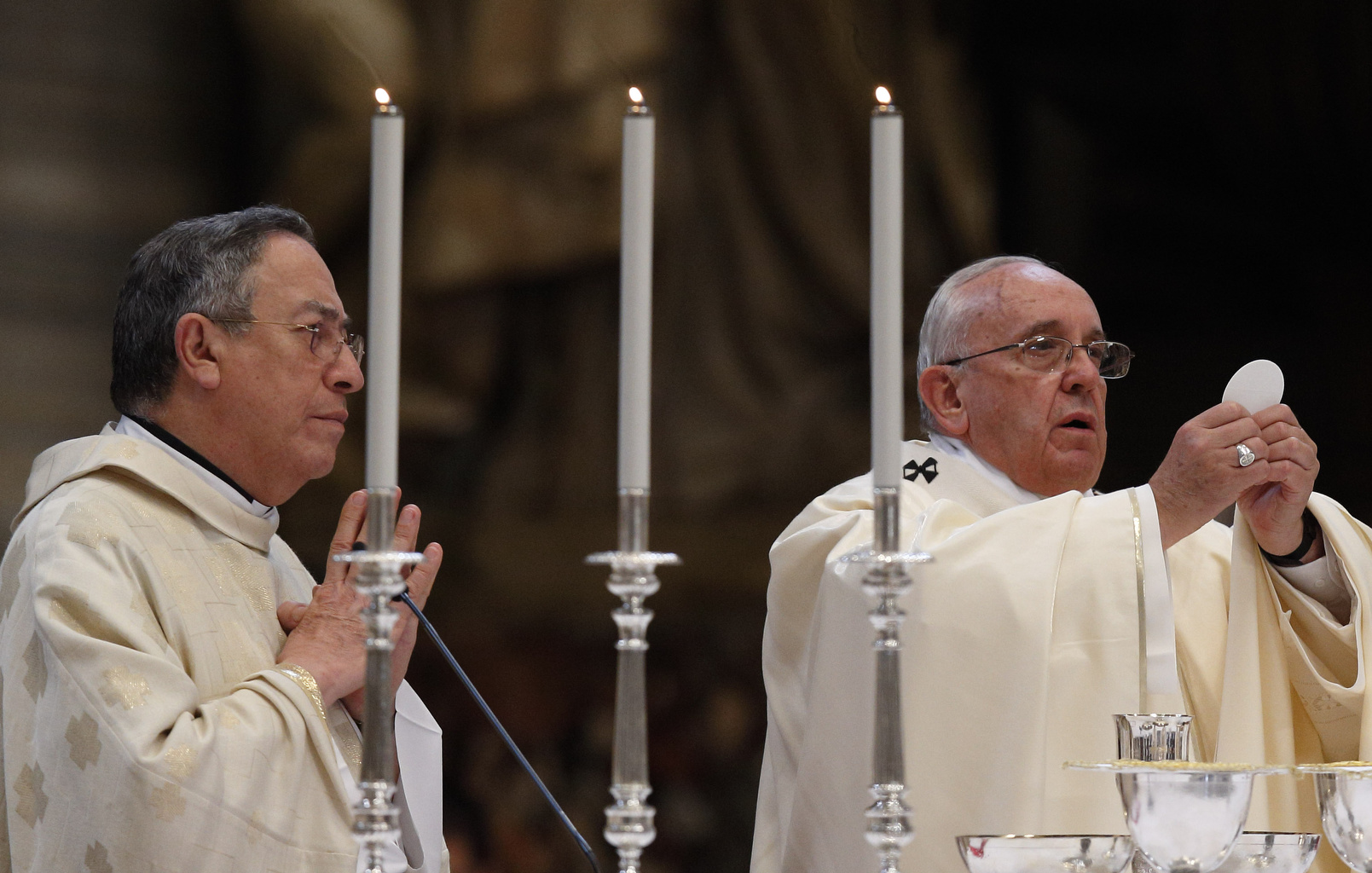 Pope Francis celebrates the Eucharist during a Mass for the opening of the general assembly of Caritas Internationalis in St. Peter's Basilica at the Vatican May 12. At left is Cardinal Oscar Rodriguez Maradiaga of Tegucigalpa, Honduras. (CNS/Paul Haring)