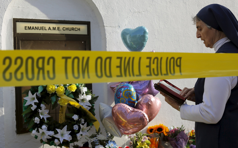 Sr. Mary Thecla of the Daughters of St. Paul prays outside the Emanuel African Methodist Episcopal Church in Charleston, S.C. June 19, 2015. Two days prior, nine people were murdered during a Bible study session at the church. (CNS/Brian Snyder, Reuters)