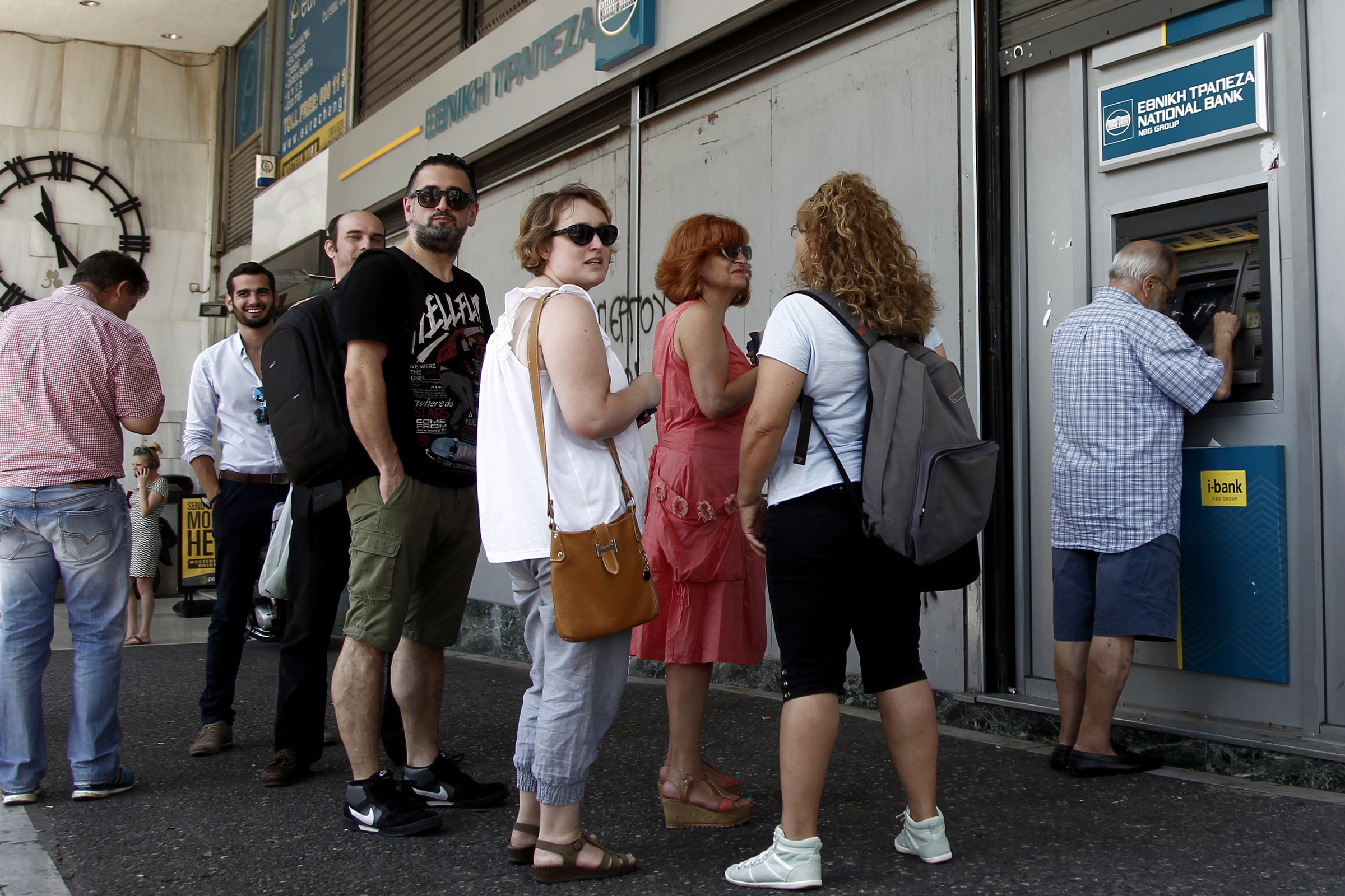 People queue to withdraw money from an ATM outside a branch of Greece's National Bank in Athens, Greece, July 6. (CNS/EPA/Alexandros Vlachos)