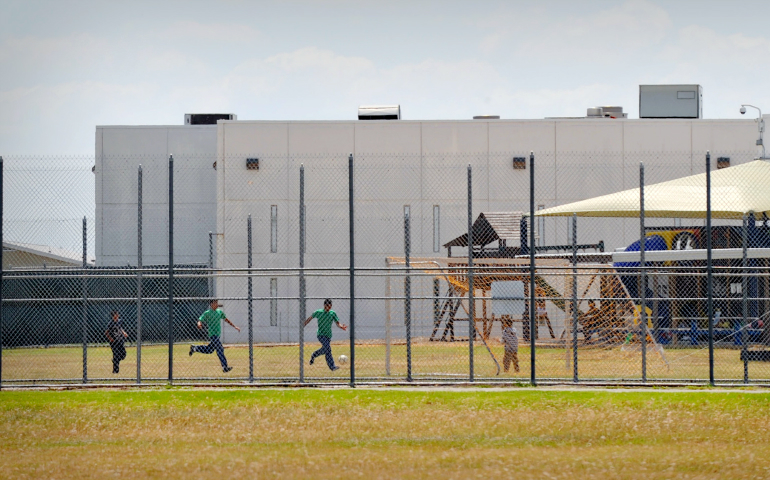 Children play in a double-fenced playground area outside the T. Don Hutto Family Residential Facility, an immigrant detention center in Taylor, Texas, in 2009. (CNS/Bahram Mark Sobhani)