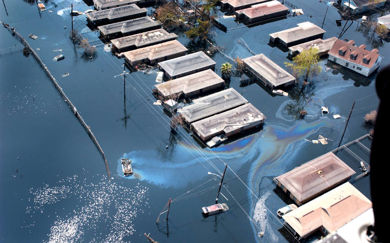 In this Sept. 10, 2005 file photo, homes are surrounded by floodwater and oil slicks in St. Bernard Parish in New Orleans, La. (CNS photo/Frank J. Methe, Clarion Herald)