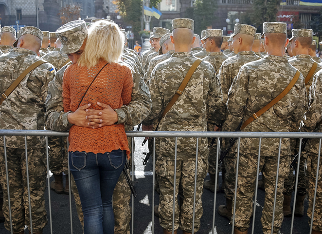 A Ukrainian serviceman hugs his girlfriend at Kiev's Independence Square Aug. 24. Ukrainians marked the 24th anniversary of Ukraine's independence from the Soviet Union. (CNS/Roman Pilipey, EPA) 