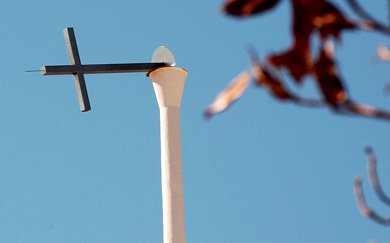 A cross hangs on a church steeple in New Orleans, La., in this 2005 file photo (CNS/Steve Pope, EPA)