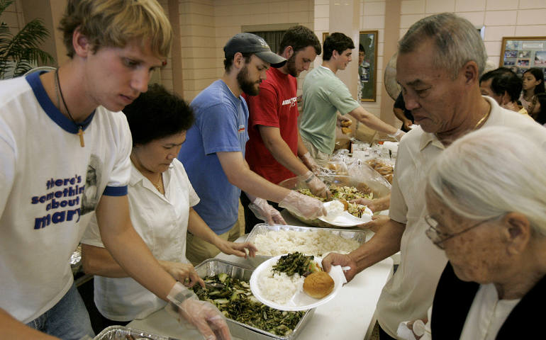 Seminarians serve food to Hurricane Katrina evacuees in 2005 at a temporary shelter in Baton Rouge, La. (CNS photo/Paul Haring)