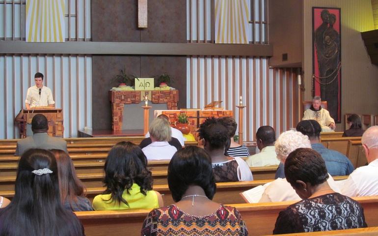 Franciscan Fr. Greg Plata and congregation listen to Scripture reading during Sunday Mass at St. Francis of Assisi Catholic Church in Greenwood, Miss., June 1, 2014. (CNS photo/Patricia Zapor)