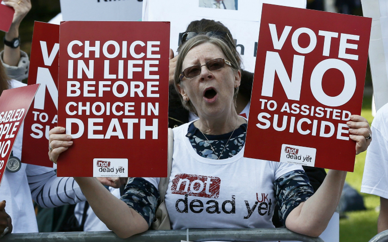 A demonstrator against "assisted dying" joins a protest outside the Houses of Parliament in London Sept. 11. Archbishop Peter Smith of Southwark has welcomed the overwhelming defeat of a bill to legalize assisted suicide in England and Wales. (CNS photo/Stefan Wermuth, Reuters) 