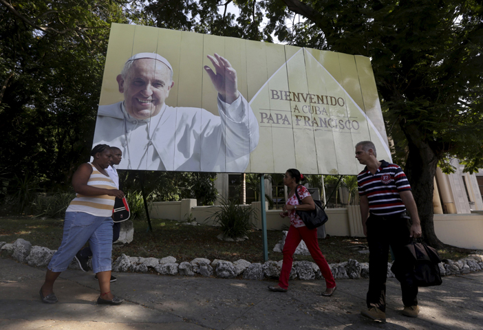 Cubans walk under a Pope Francis billboard in Havana, Sept. 14, 2015. (CNS/Enrique de la Osa, Reuters)