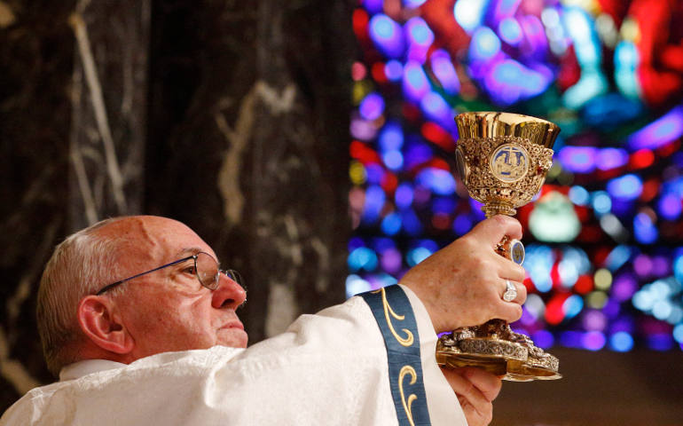 Pope Francis raises the chalice of the Eucharist as he celebrates Mass with representatives from the Archdiocese of Philadelphia at the Cathedral Basilica of SS. Peter and Paul in Philadelphia Sept. 26. (CNS photo/Paul Haring)