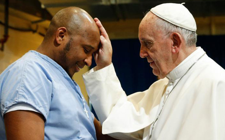 Pope Francis blesses a prisoner as he visits the Curran-Fromhold Correctional Facility in Philadelphia Sept. 27, 2015. (CNS/Paul Haring)