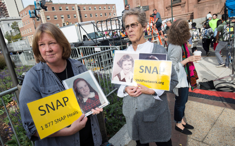 Becky Ianni of Burke, Va., and Barbara Dorris of St. Louis, both members of Survivors Network of those Abused by Priests demonstrate in front of the Cathedral Basilica of SS. Peter and Paul in Philadelphia Sept. 25, 2016. (CNS / Joshua Roberts)