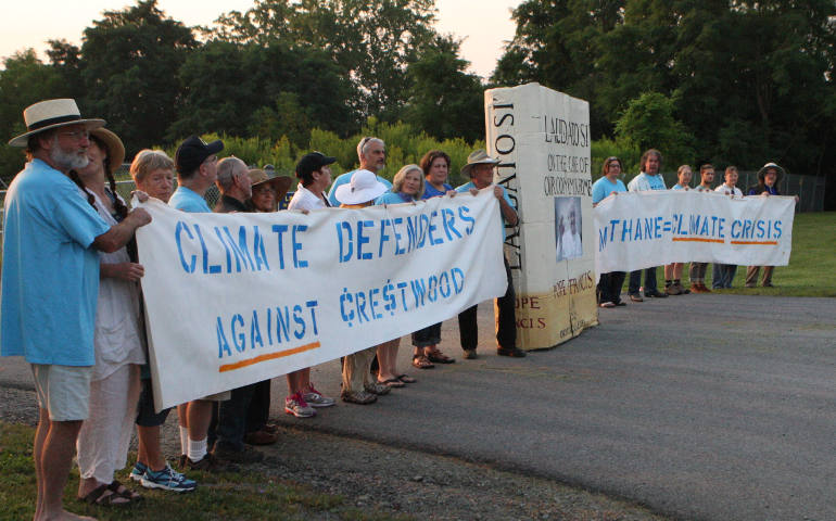 A line of protesters Aug. 18 blocks the main gate at the Crestwood Midstream Partners gas storage facility on the shores of Seneca Lake in Reading, N.Y., near Watkins Glen, N.Y. Eighteen people were arrested while reading Pope Francis' encyclical "Laudato Si'." (CNS photo/Dennis Sadowski)