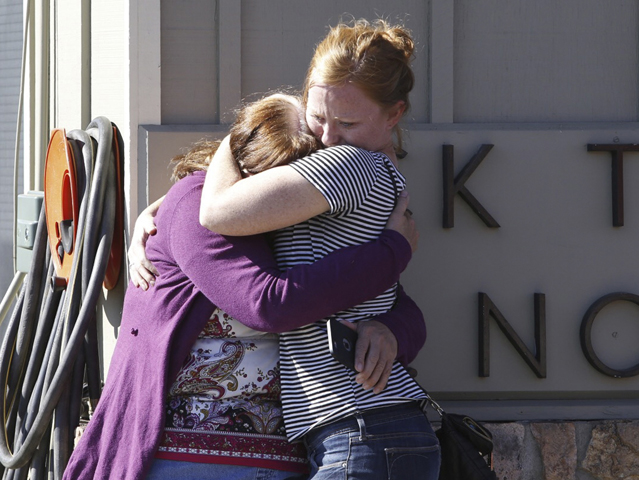 Umpqua Community College alumna Donice Smith, left, is embraced after learning one of her former teachers was killed in Roseburg, Ore., Oct. 1. (CNS photo/Steve Dipaola, Reuters)