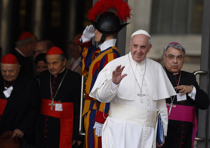 Pope Francis waves as he leaves the opening session of the Synod of Bishops on the family at the Vatican Oct. 5. (CNS photo/Paul Haring)