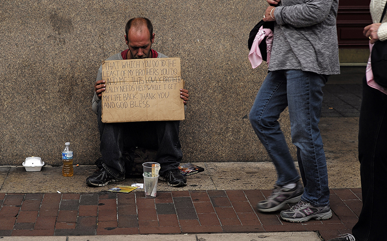 A homeless man sits on a sidewalk in Philadelphia Sept. 26, 2015. (CNS/CJ Gunther, EPA)